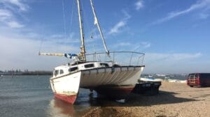 A derelict boat on the seafront.