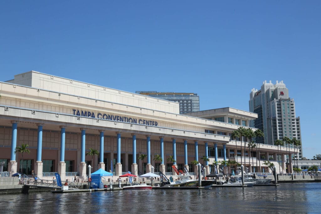 Large waterfront building with pontoons leading down to the water's edge.