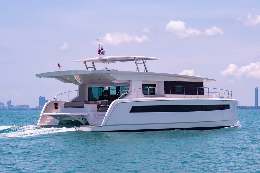 Catamaran yacht cruising near harbour waters.