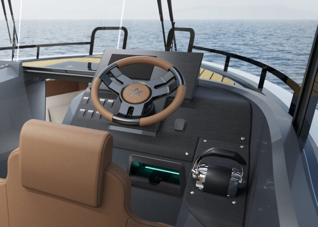 Cockpit of motorboat showing steering wheel, throttle and mobile phone charging pod, with views ahead of the sea and horizon.