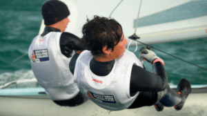 Two young people sailing a dinghy