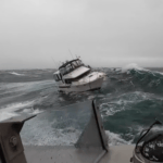 Motor boat lists in heavy sea during US Coast Guard rescue