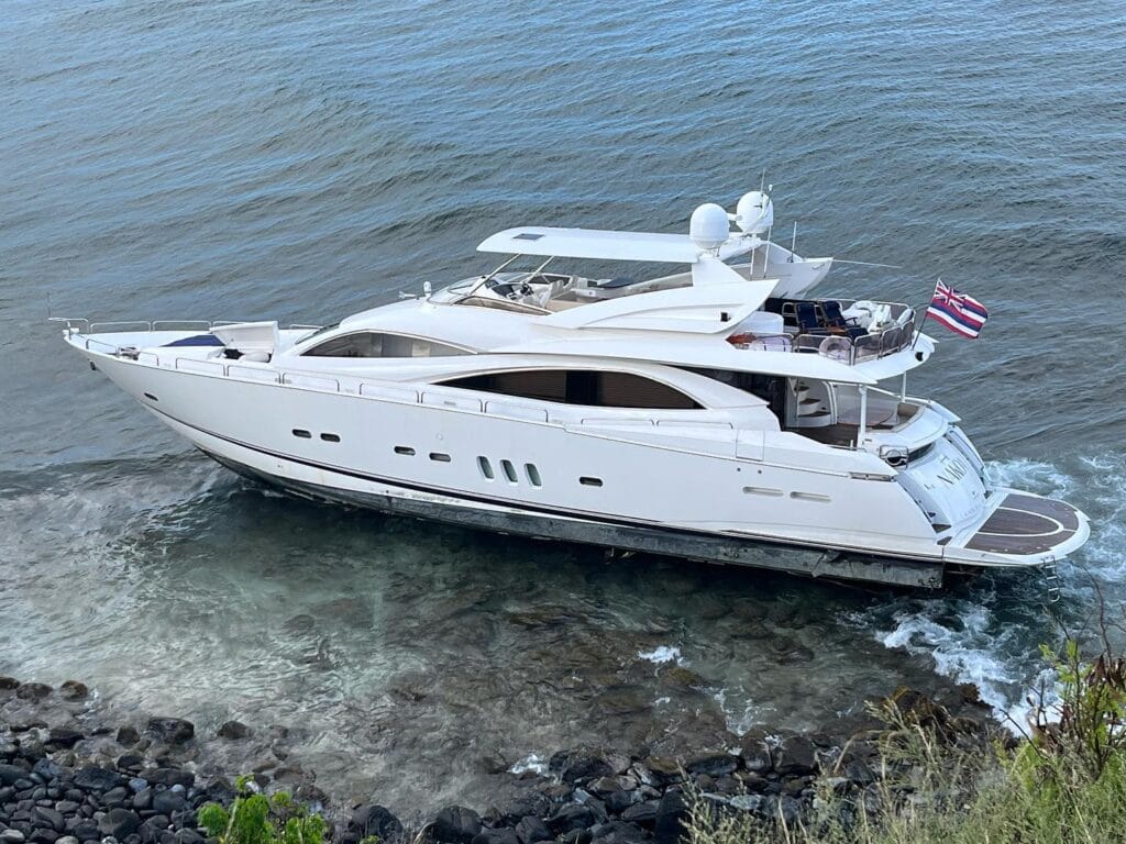 Luxury yacht aground on rocks and reef