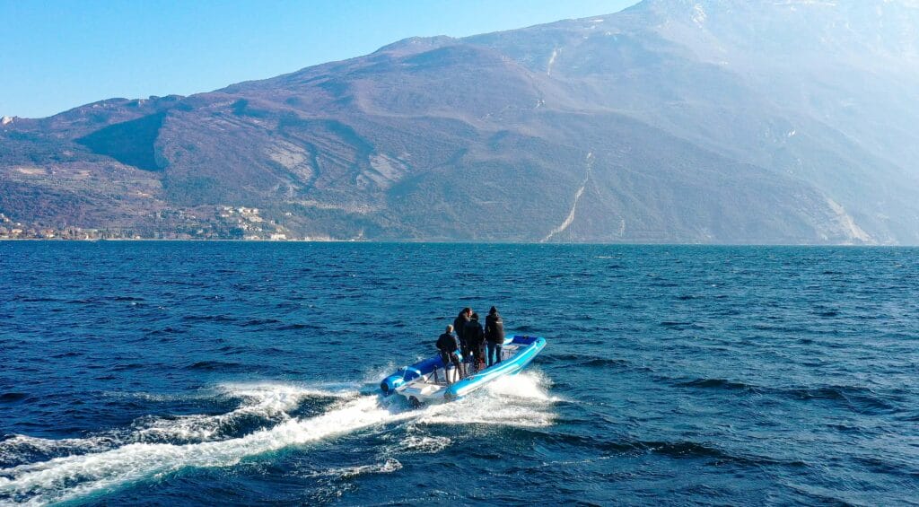 Blue RIB on a lake with mountains in the background