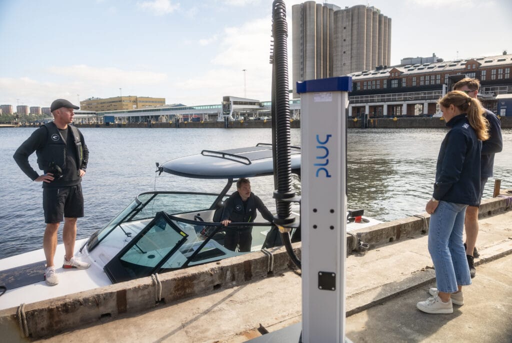 Electric boat alongside charging station