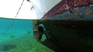 white and red boat in water propeller