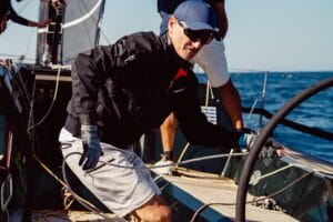 Man on yacht wearing Henri-Lloyd marine clothing.