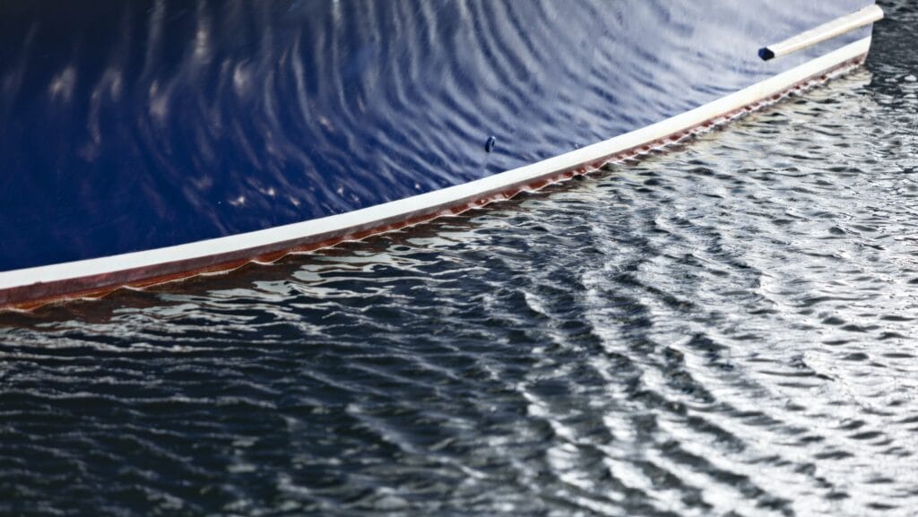 Boat with rippling water reflected