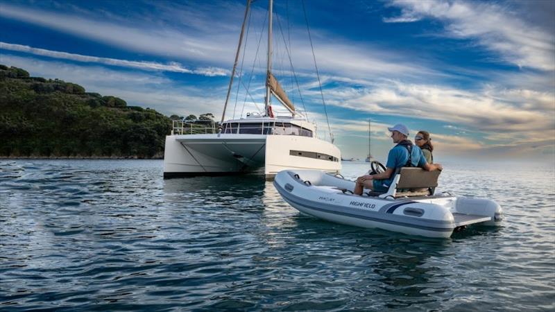 ZeroJet electric powered small tender boat and a white catamaran in the distance © ZeroJet