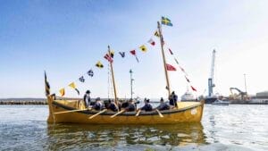 Yellow rowing boat with flags, on a calm sea