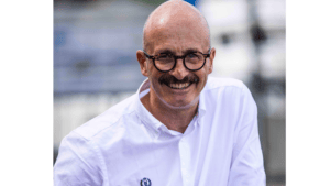 Man in glasses and white shirt looks at camera