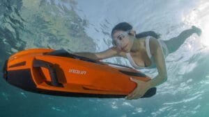 Swimmer under the water, holding onto a water toy as iAqua offer water toy trade ins