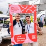 People pose during World Boating Day 2024