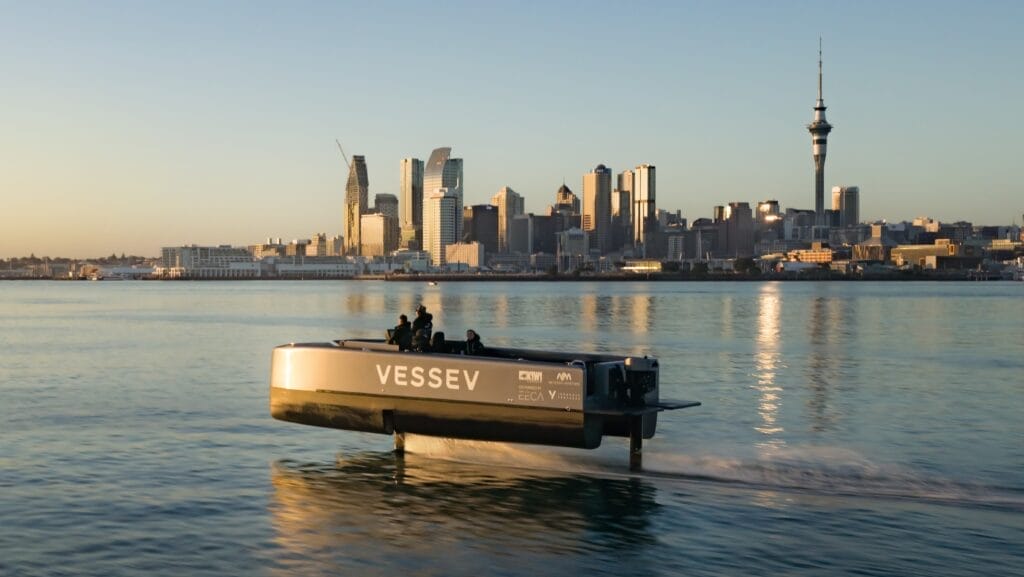 electric foiling boat with Auckland in the background
