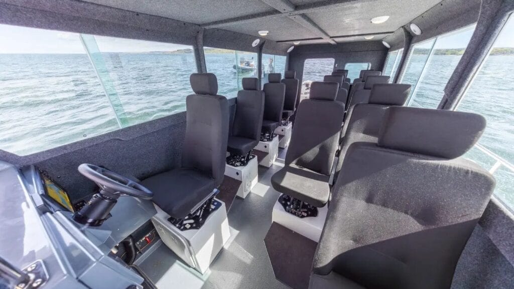 Interior of workboat showing 12 grey seats