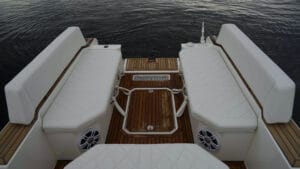 Interior of flat deck Agilis Jettender 500D with white seats and fold down swim platform