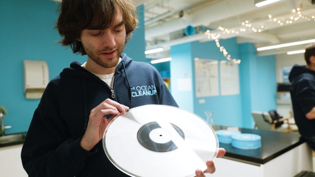 Man looking at large plastic LP
