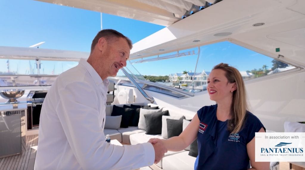 man and woman (Amanda from Docherty Marine) shake hands on boat while discussing Dockmate