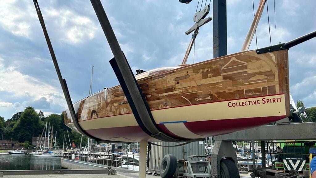 Boat made of 1200 wooden items in sling. Collective Spirit was Olympic art project.