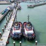Two small workboat tugs alongside pontoon