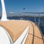 looking along the bow and teak deck of a luxury yacht