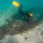 diver examines bones of boat wreck underwater. This is Roman boat found near Formentera where new IBEAM centre being set up