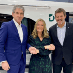 Three people shake hands on a deal which sees Le Boat invest into Groupe Beneteaus Delphia