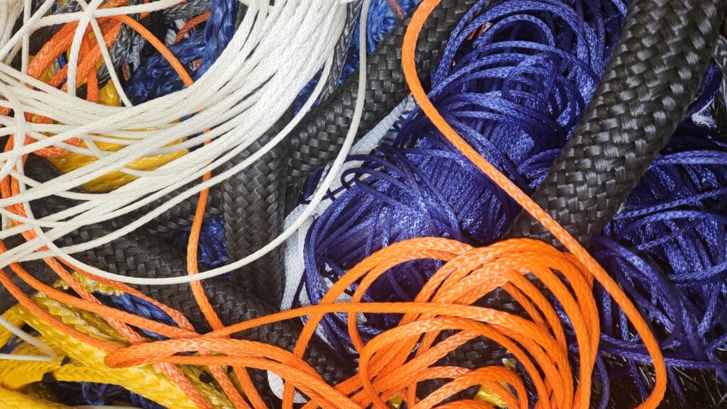 pile of different coloured sailing rope and yarn