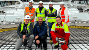 Group of students from IKEA and instructors on deck of cargo ship