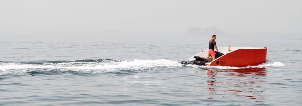 side view of boat hull being powered by jet ski