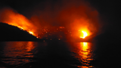 island burns in Greece as suoeryacht crew charged with starting fire with fireworks
