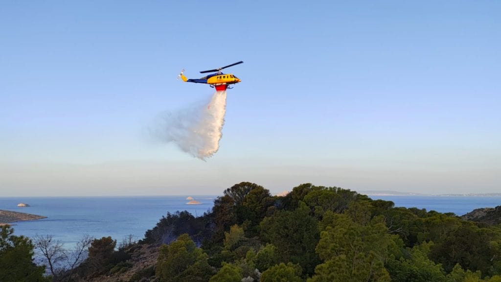 helicopter drops water on fire in Greece as suoeryacht crew charged with starting fire with fireworks