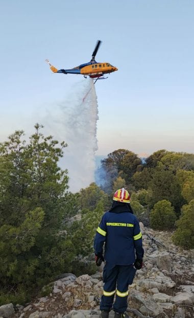 helicopter drops water on fire in Greece as superyacht crew charged with starting fire with fireworks