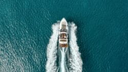 birdseye view of luxury powerboat with wake