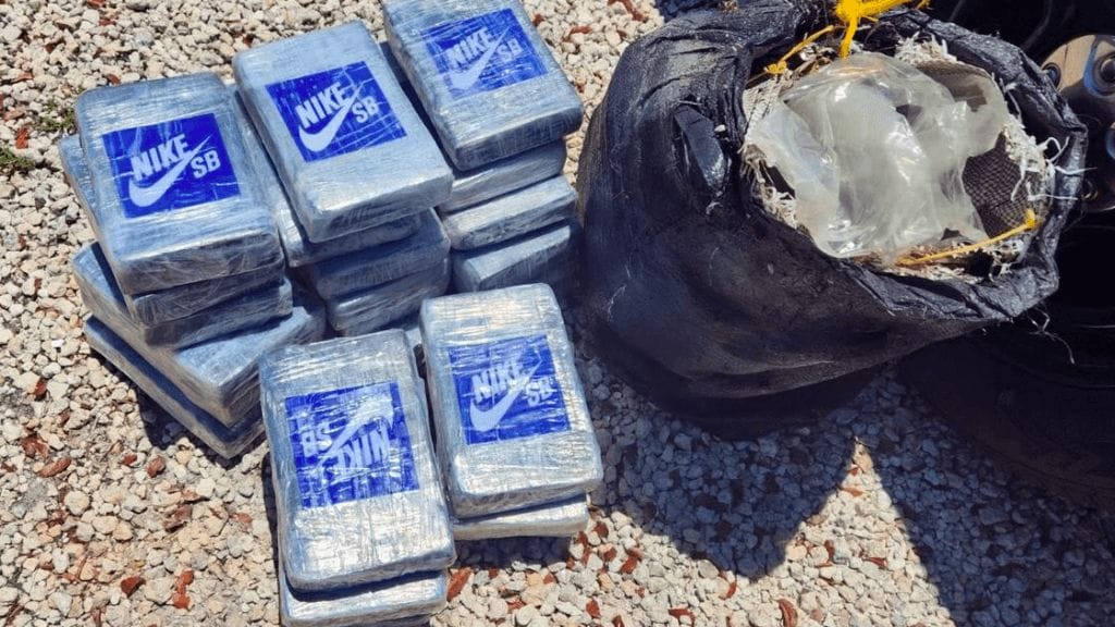 packets of cocaine found on beach in Florida. These have blue Nike logo on them and are pictured next to a black bin liner