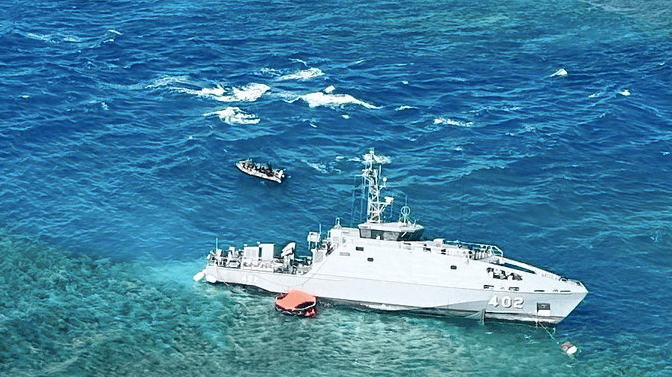 overhead image of rescue efforts around Fiji navy patrol boat grounded on a reef