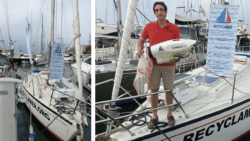 man on sail boat holding the Turbino - a new underwater microplastics collecting vacuum system