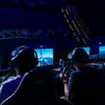 Gamers sit around looking at screens as they play AC Sailing, a simulation of what it's like to sail a boat