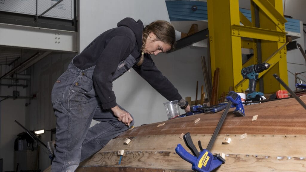 A boatbuilder works in a workshop..