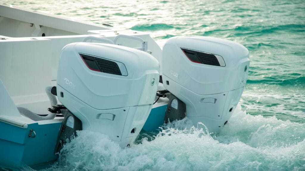 two of Cox Marine diesel outboards on the back of a boat