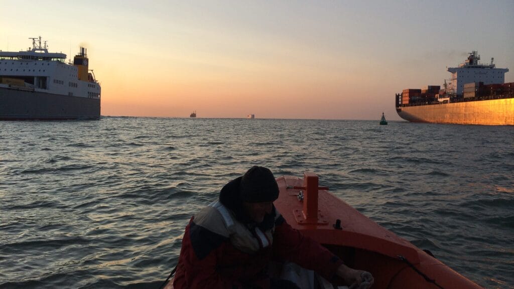 RIB between two large ships in a shipping lane of Thames Estuary