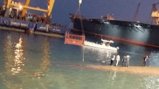 Iranian Navy's Sahand destroyer frigate sinks in Iran port as people are seen walking on its submerged hull