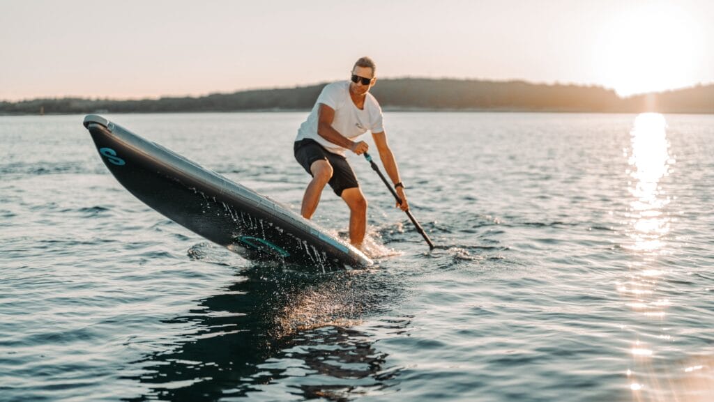 Man on Electric stand up paddleboard - on show at Sydney International Boat Show 2024