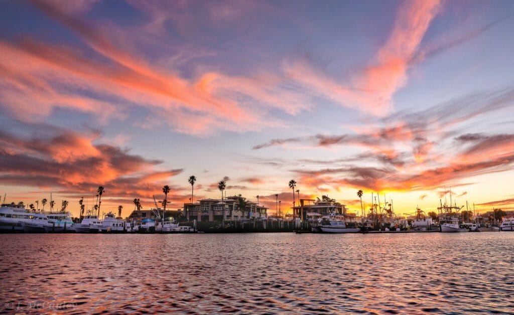 Pink and orange sunset over marina slips in California's Marine Emporium Landing marina