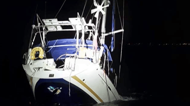yacht's stern above the water as it sinks. Owner says orca orchestrated attack