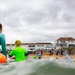 children in shallow water with buoyancy aids