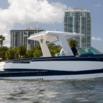 Aviara boat shown on water with city backdrop as MarineMax enters into agreement to take over brand