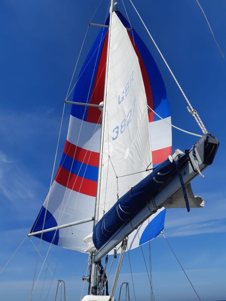 yacht boom with spinnaker above it