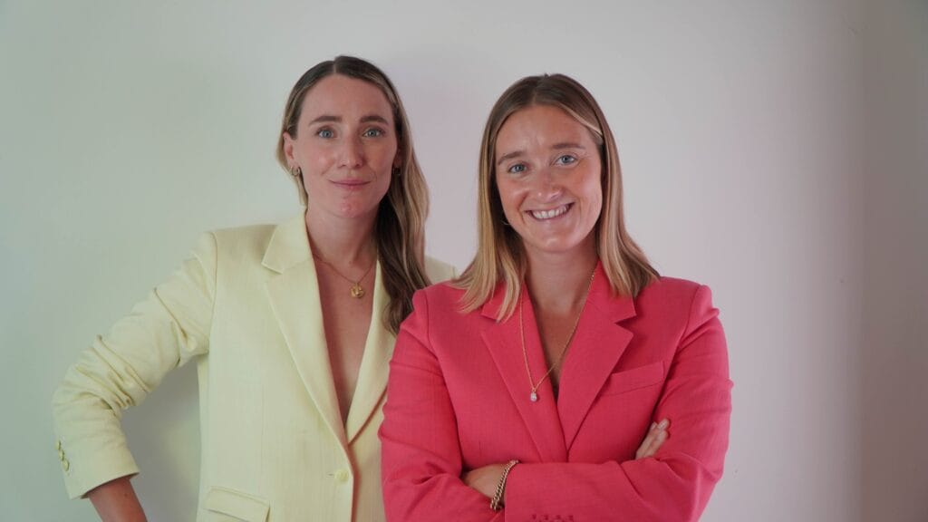 One business women in lemon coloured blazer and one woman in a pick blazer