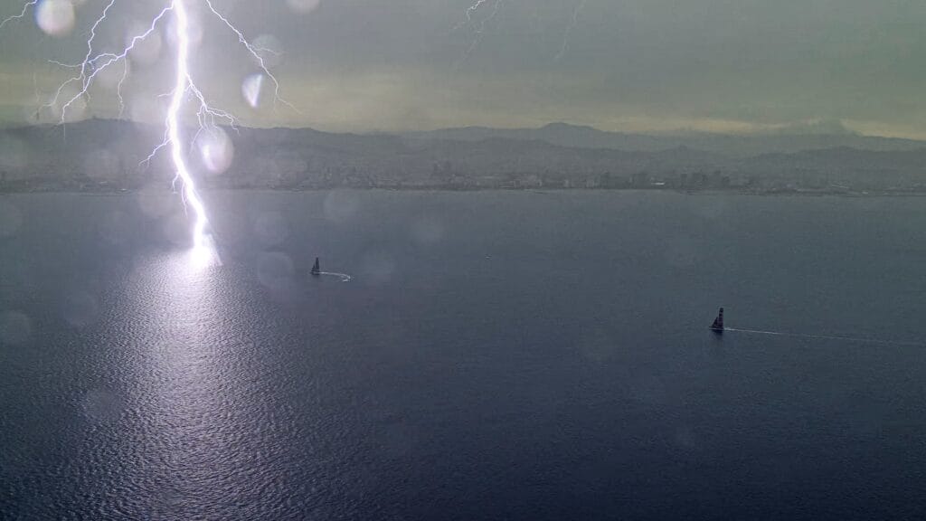 view from the air of lightening striking the water in Barcelona at America's Cup